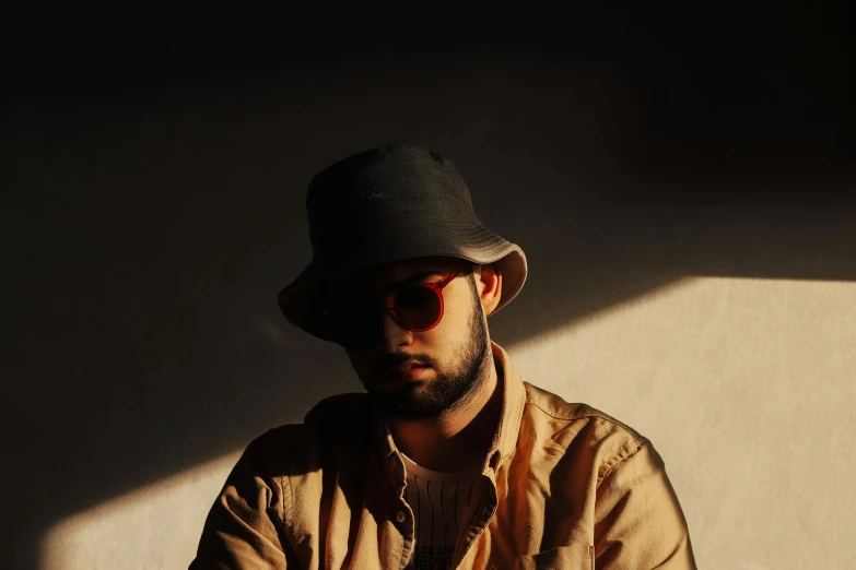 a man wearing sunglasses and a hat in the sun