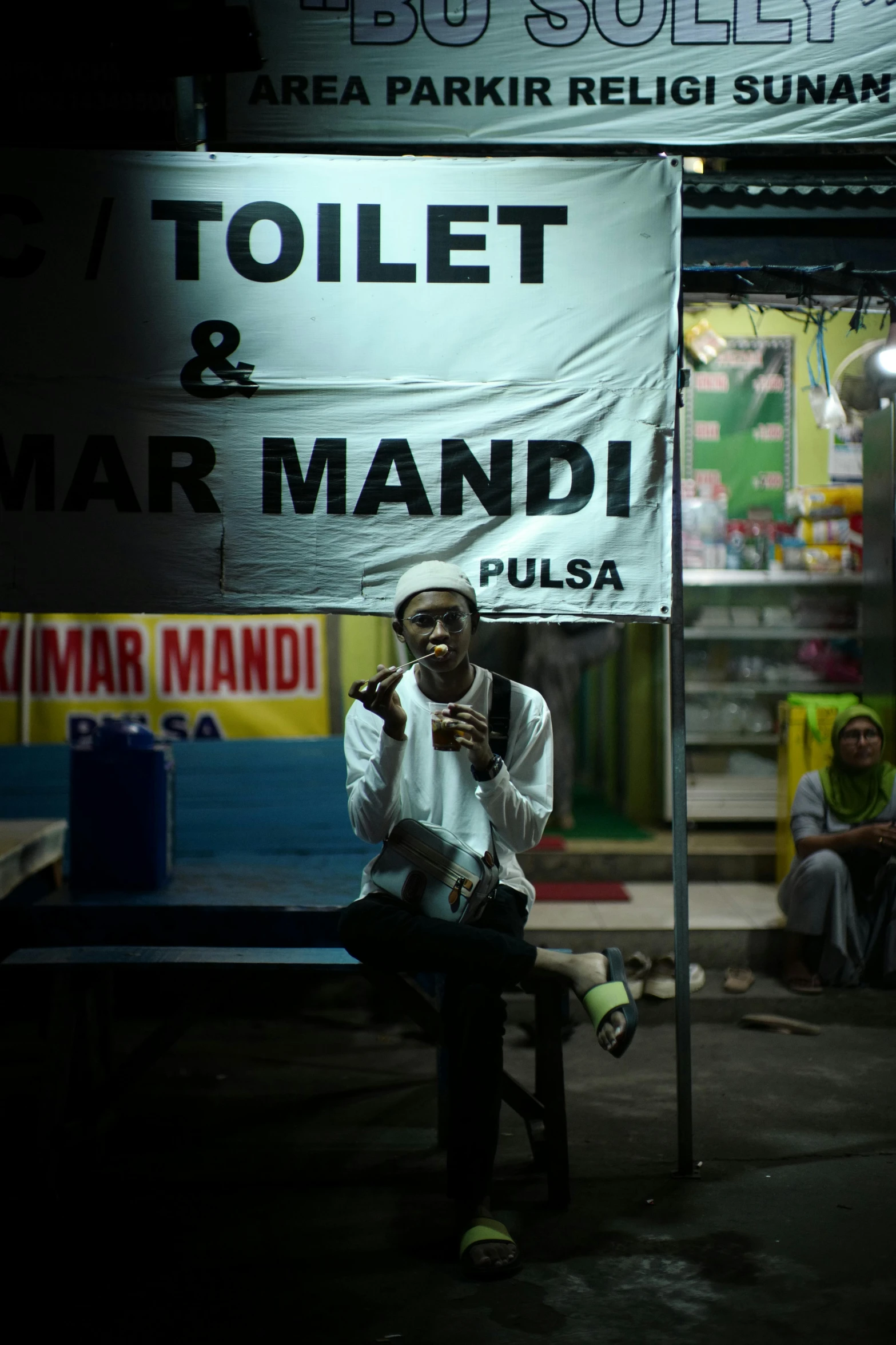 a man sitting on a bench talking on a phone