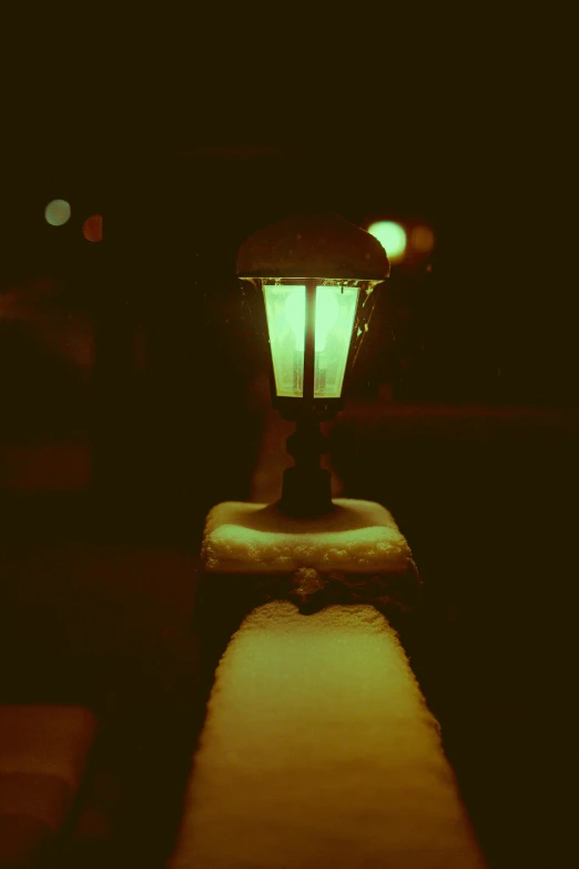 a lamp is lit on the edge of the street