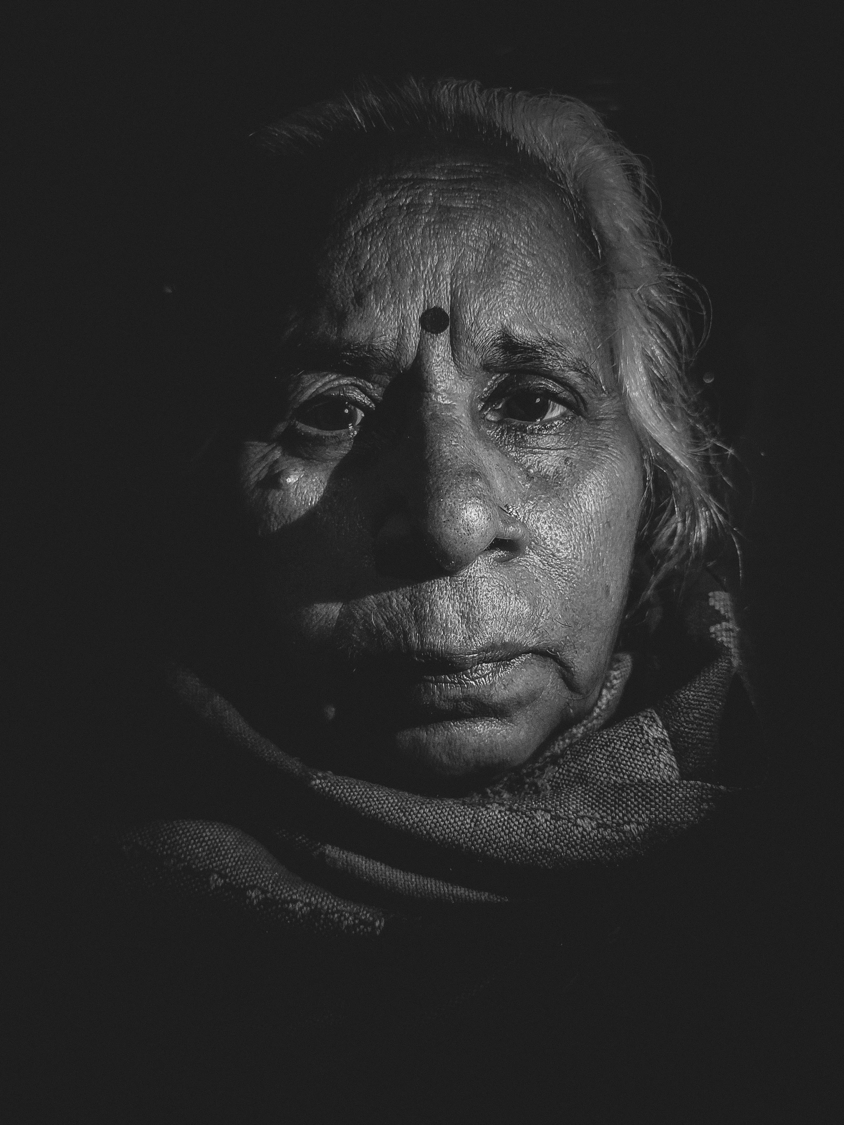 woman with white hair looking up into the dark