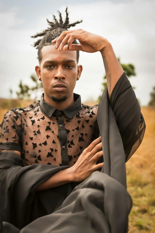 a man wearing a shirt and pants posing for the camera