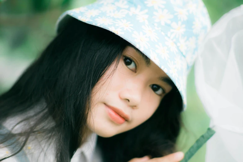 this little girl is holding her umbrella looking at the camera