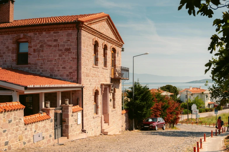 a car parked near a brick building near the water