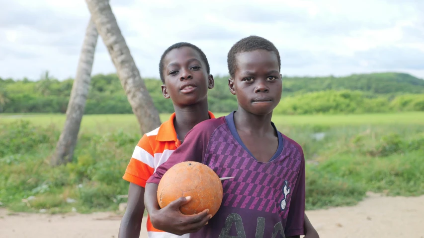 two little girls with a big ball in their hands