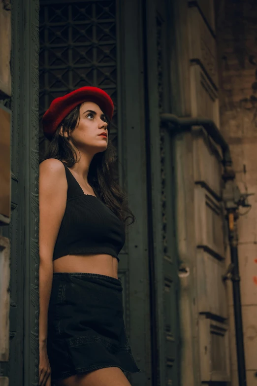 a young woman wearing a red hat is posing for the camera