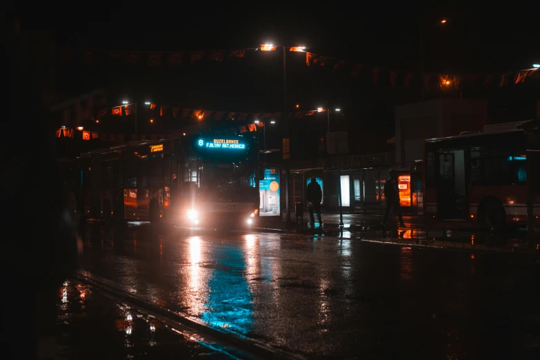 a city street at night with cars and people walking across the road