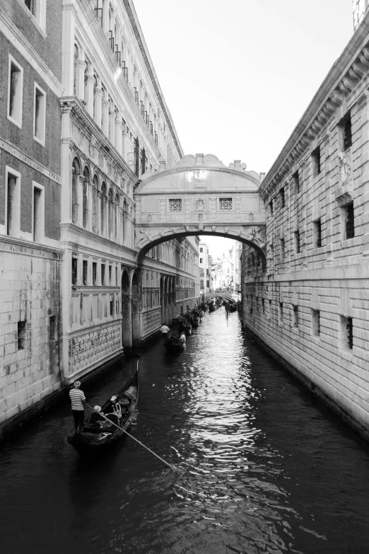 people are going down the canal on small boats