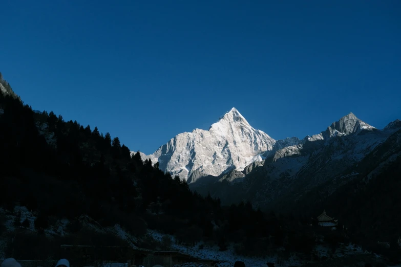 the snowy mountains glow as people ski