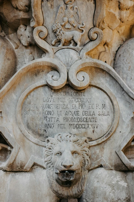 an animal statue in front of a relief in stone