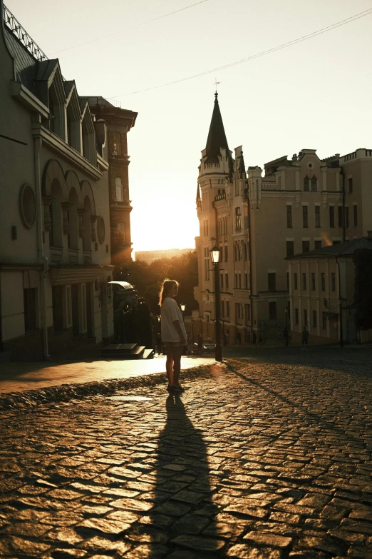 person standing in the middle of a large cobble stone courtyard