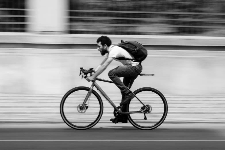 the man is riding his bicycle on the street