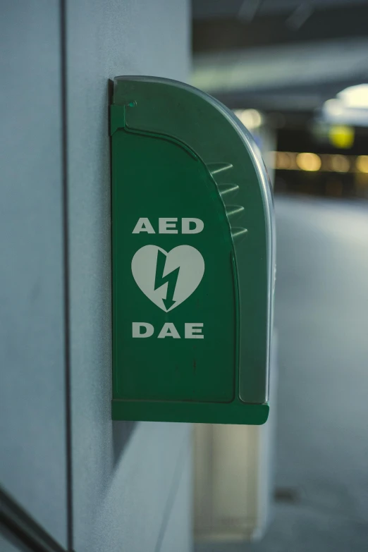 a green sign that says aed day attached to a building