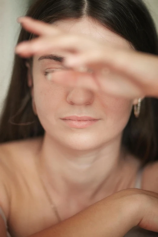 a blurry po of a girl's face and hands