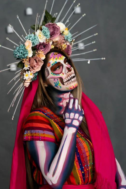 a woman with painted body art and flowers covering her face