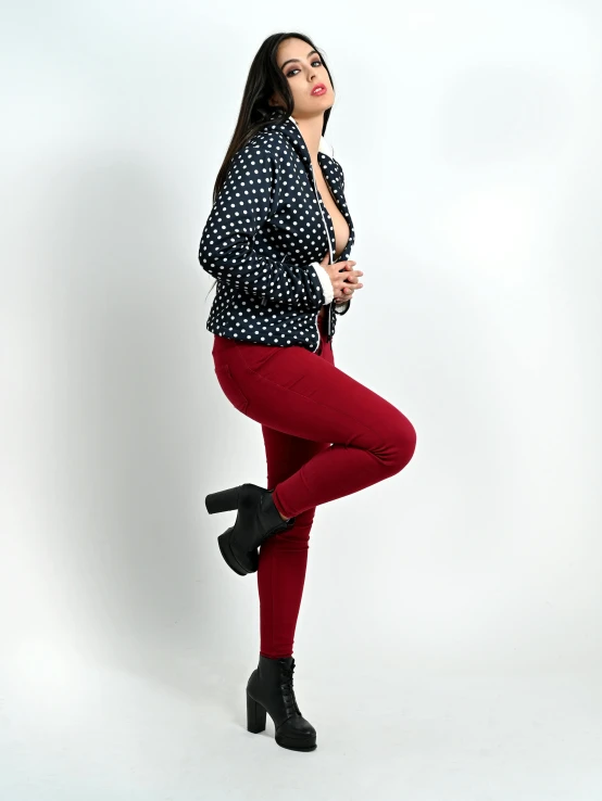 a woman in a polka dot top and red tights
