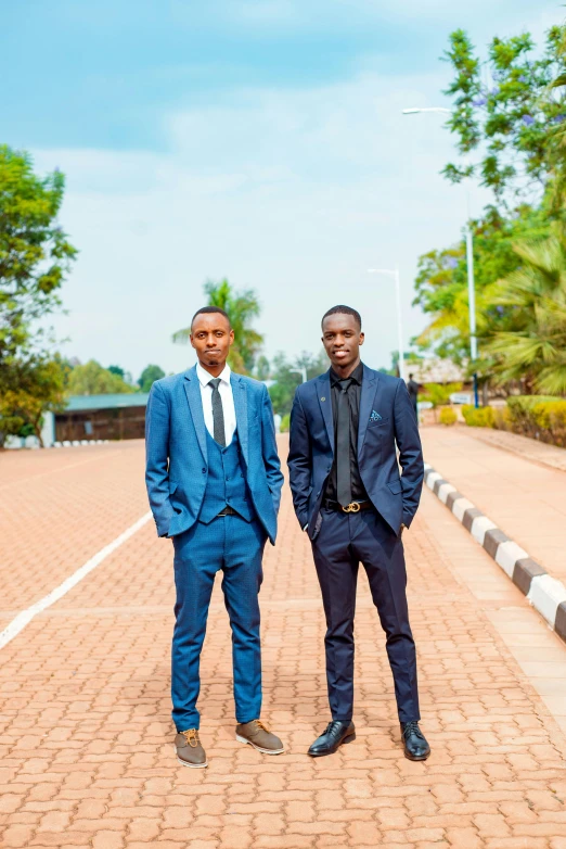 two men in suits standing on a red brick road