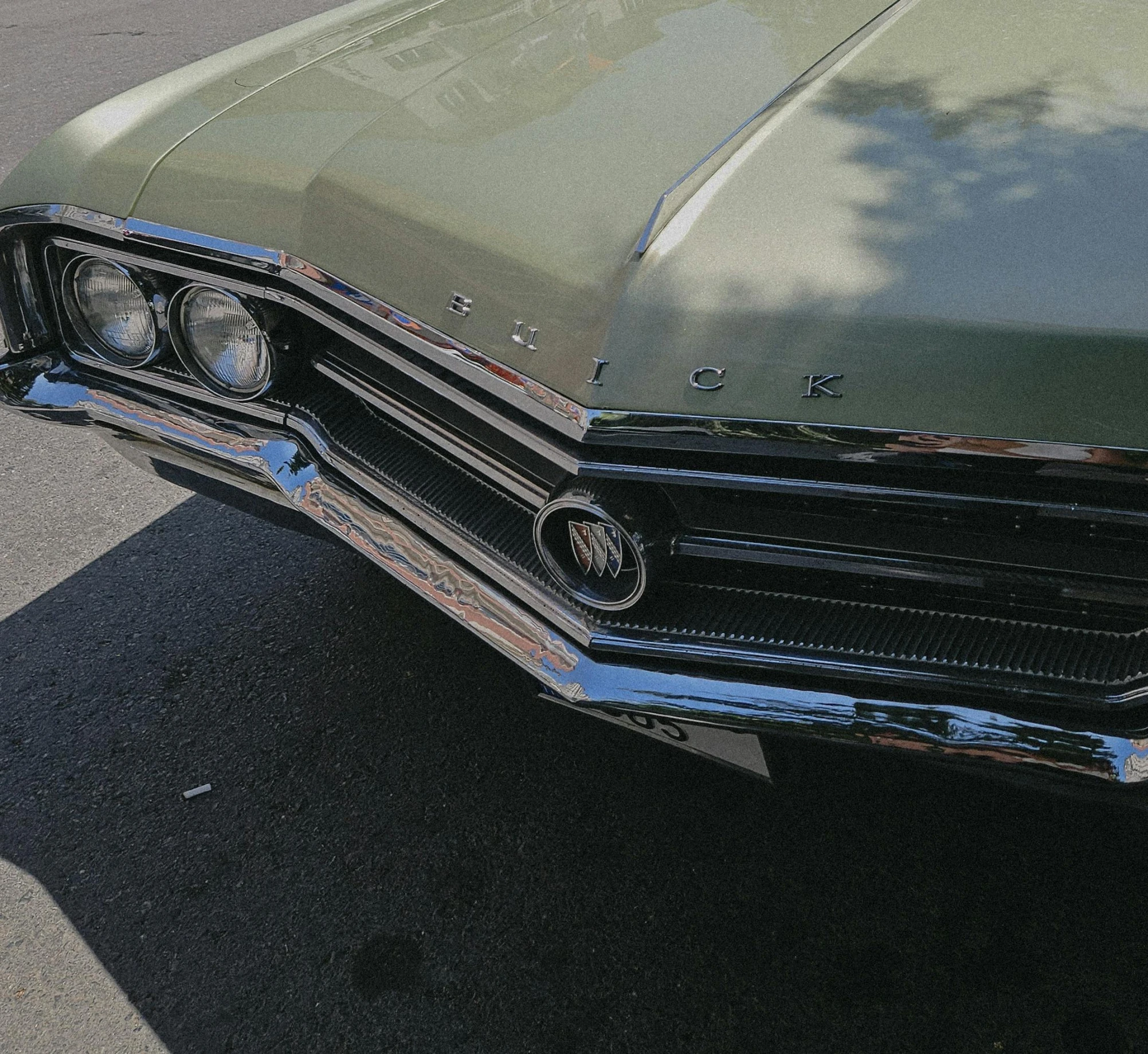 an old green car is shown in shadow