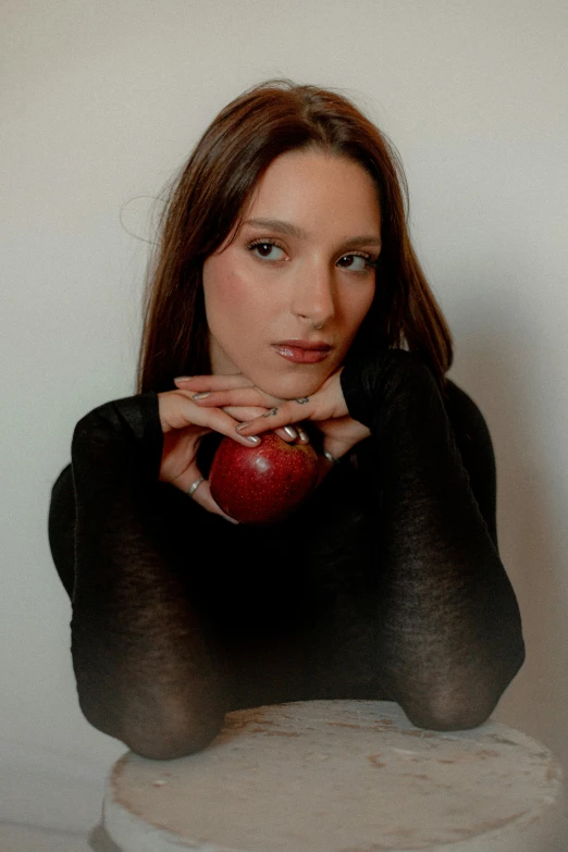 an image of a girl holding an apple posing for the camera