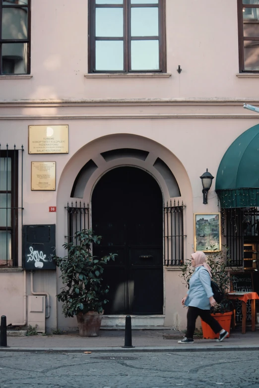 the old woman is walking outside of the building