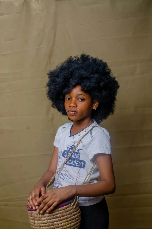 little black girl with afro holding basket and looking forward