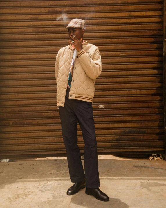 a man in a winter jacket smoking a cigarette