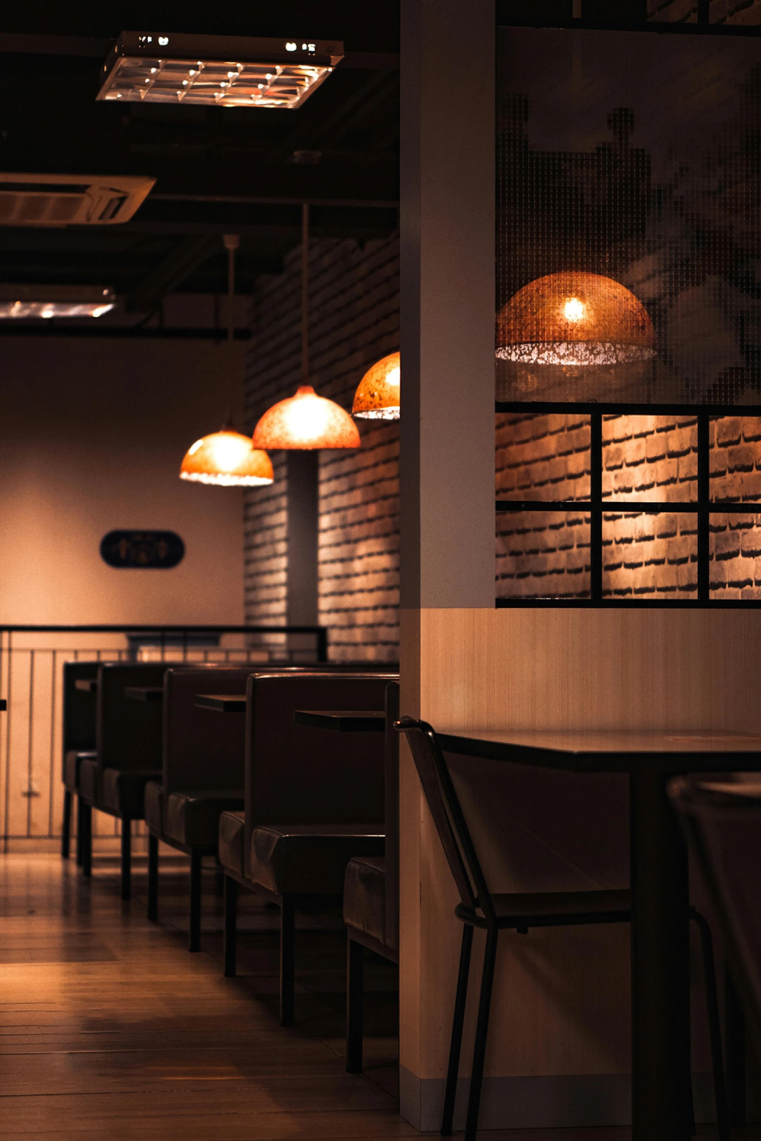 a dimly lit empty bar with stools