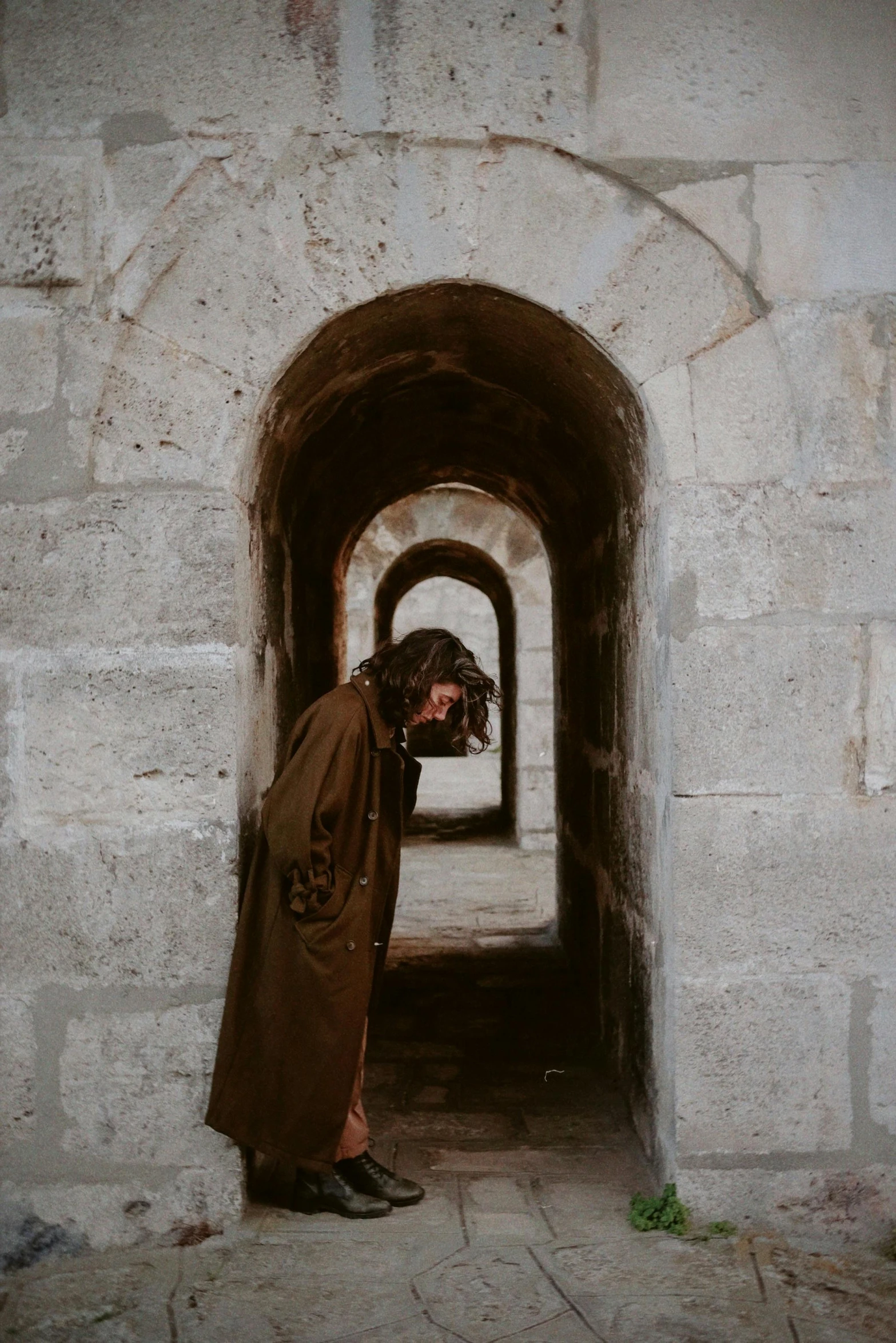 a person with an umbrella in a tunnel