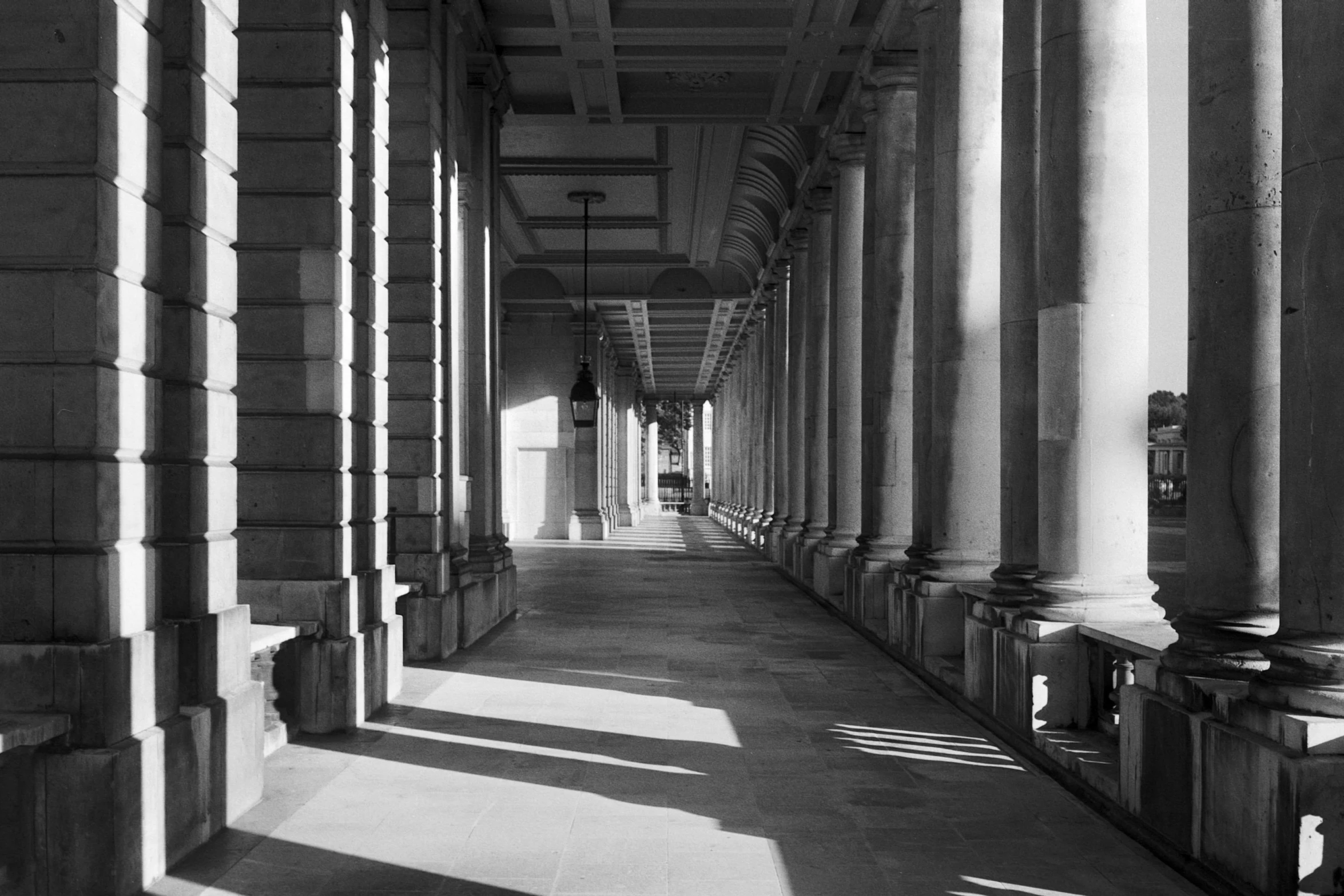 black and white po of a long corridor between two buildings