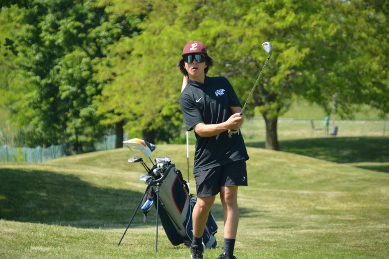 a man with a hat, glasses and golf club