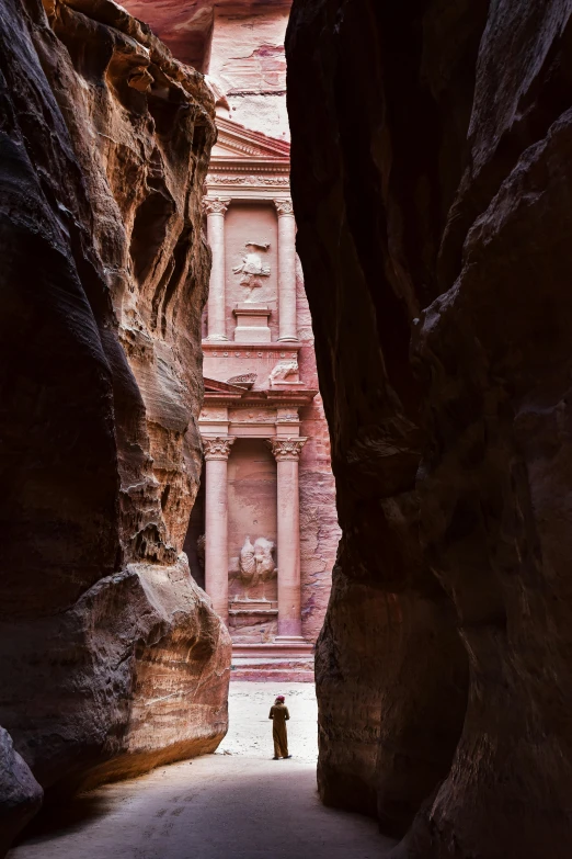 a narrow walkway is built into the side of a large rock