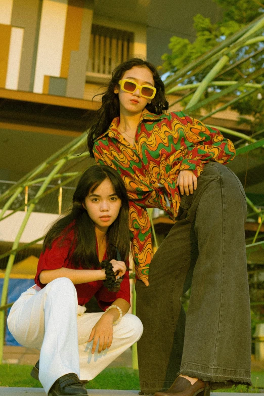 two beautiful young women dressed in bright clothing