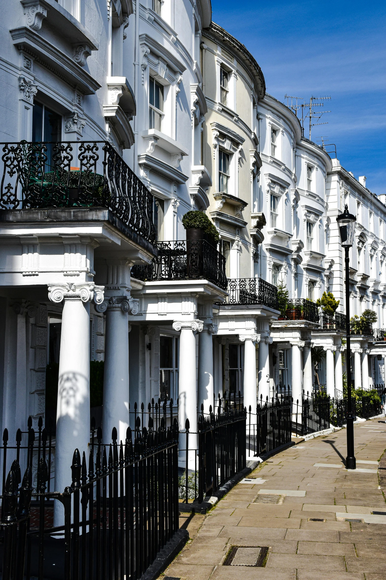 many white town houses with black fences