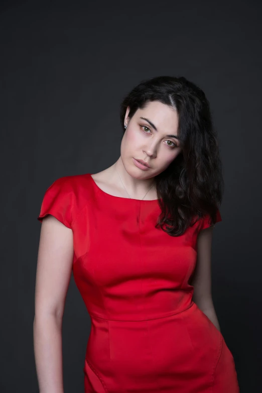 an attractive woman in red posing with her hair blowing back