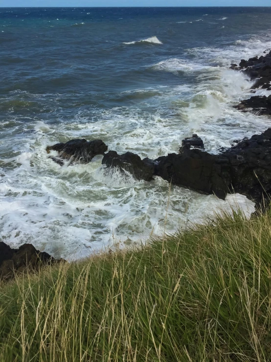 an ocean view from a cliff with some rocks