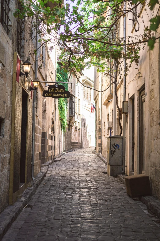 a cobblestone street is shown with stone buildings