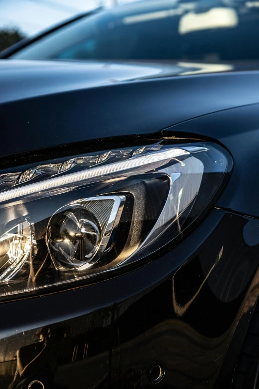 headlight on a black car in the day time