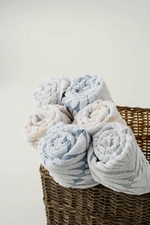 towels are piled in a basket on the floor