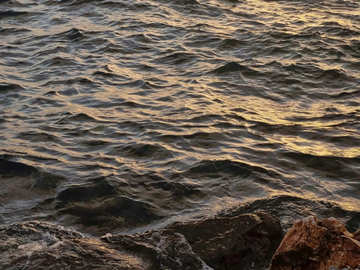 water with small waves coming onto the beach