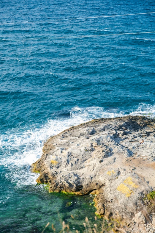 a man rides a wave on a surfboard as the sun shines