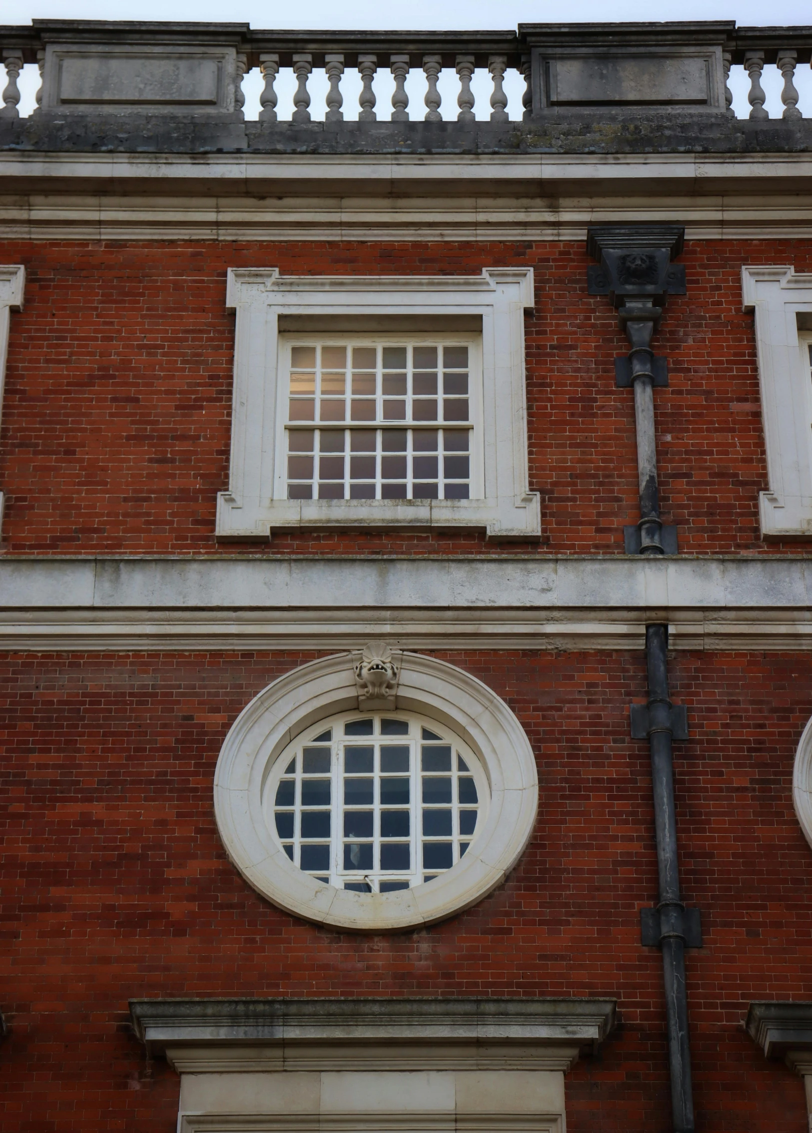 a building with two windows next to a light pole