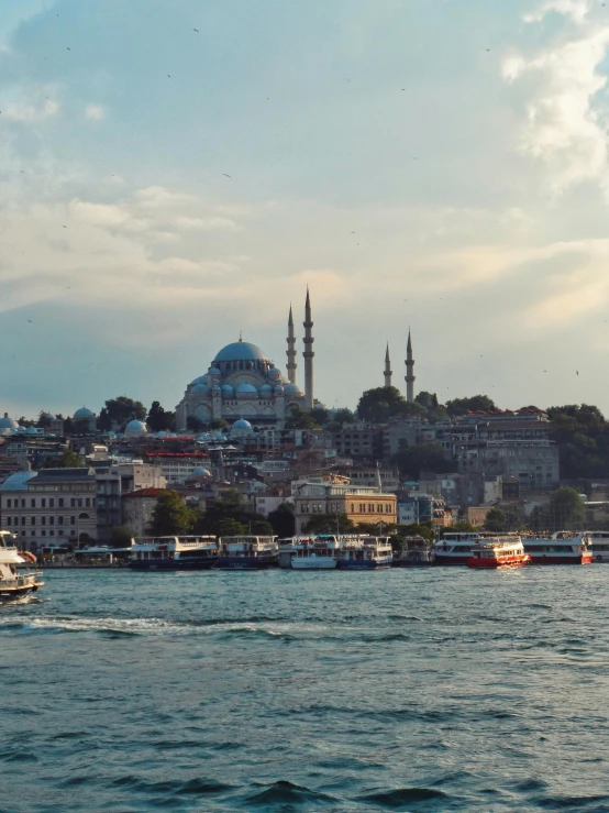 a large blue mosque with towers in the middle of a river