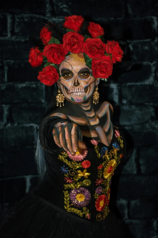 the skeleton is adorned with flowers on her head