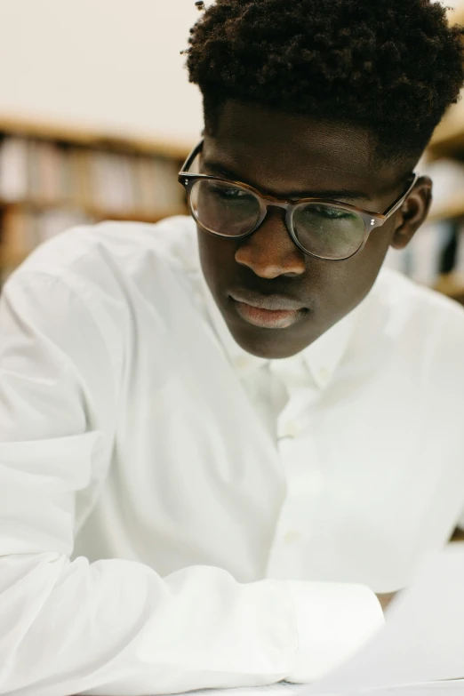 a man looking down as he takes notes in a liry