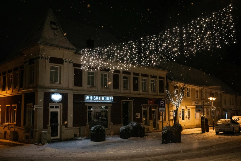 several people are outside at night in the snow