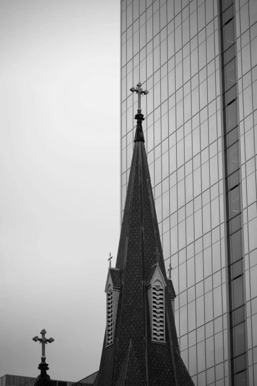 black and white picture of a church with a reflection of another building in the window