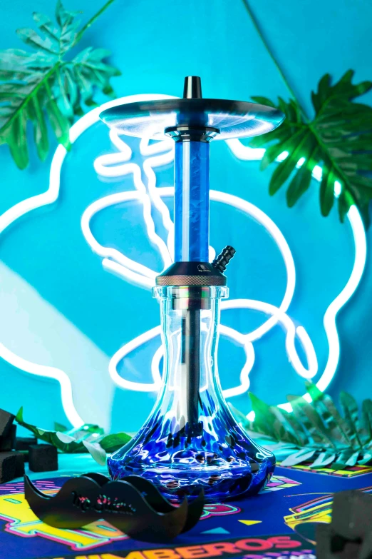 a glass table has an electric hookah on it