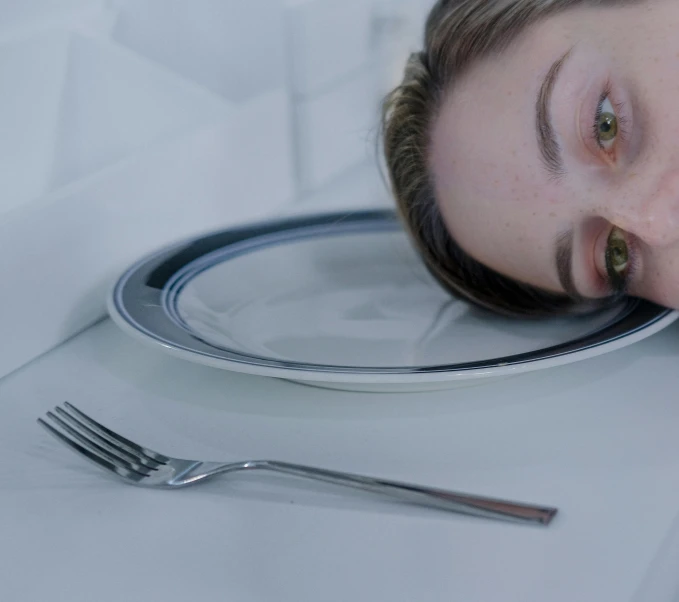 a woman is laying down on a plate