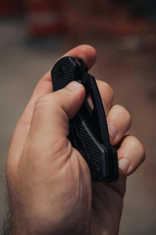 a man is holding the top part of a cellular phone