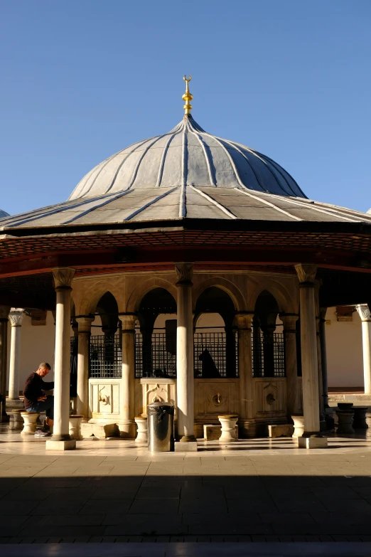 a covered patio in front of a blue sky