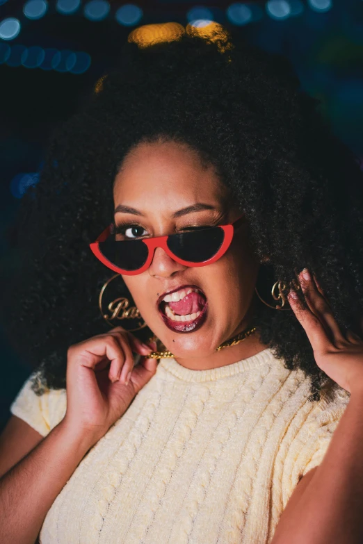 a woman in yellow shirt and red sunglasses looking shocked